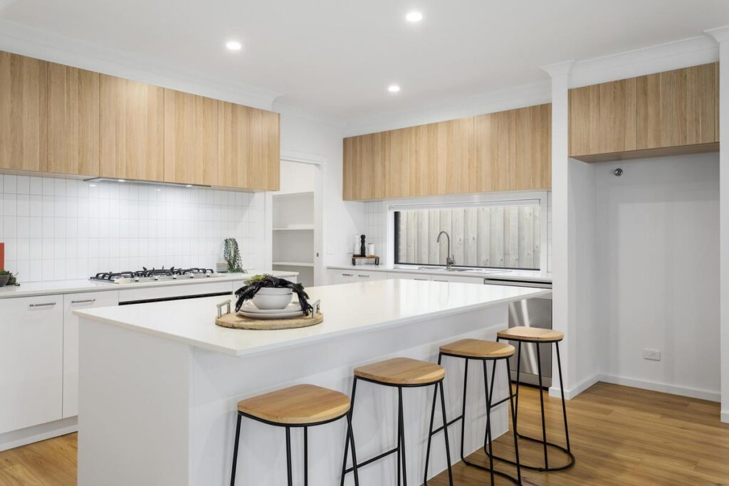 Kitchen with island bench and breakfast stools in a Byron Road custom home by Brownhill Homes