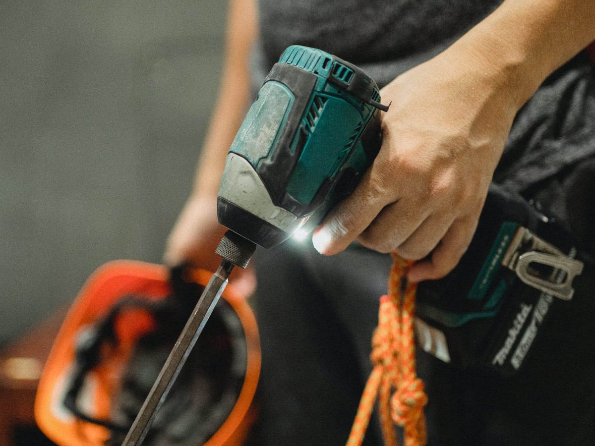 Makita Impact Driver held by a person, illustrating the tools used in Brownhill Homes' craftsmanship.